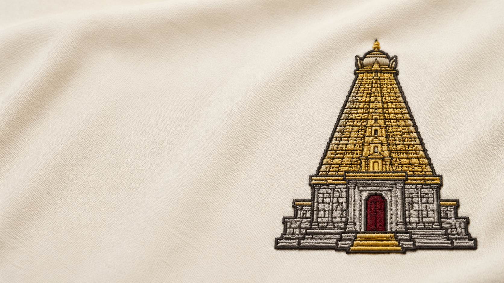 Machine-embroidered Brihadeeswarar Temple vimana emblem on cream