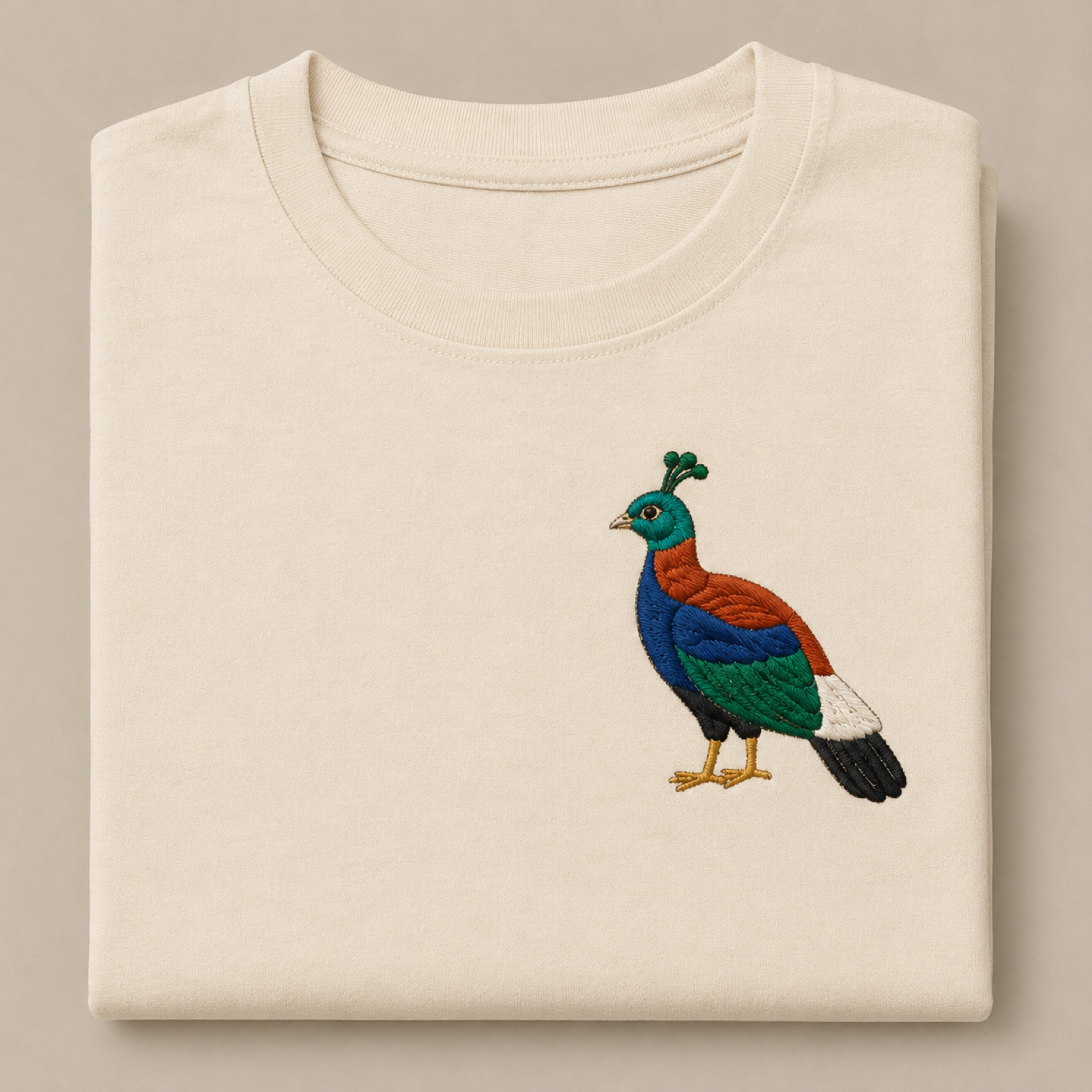 Machine-embroidered Himalayan Monal bird on a t-shirt