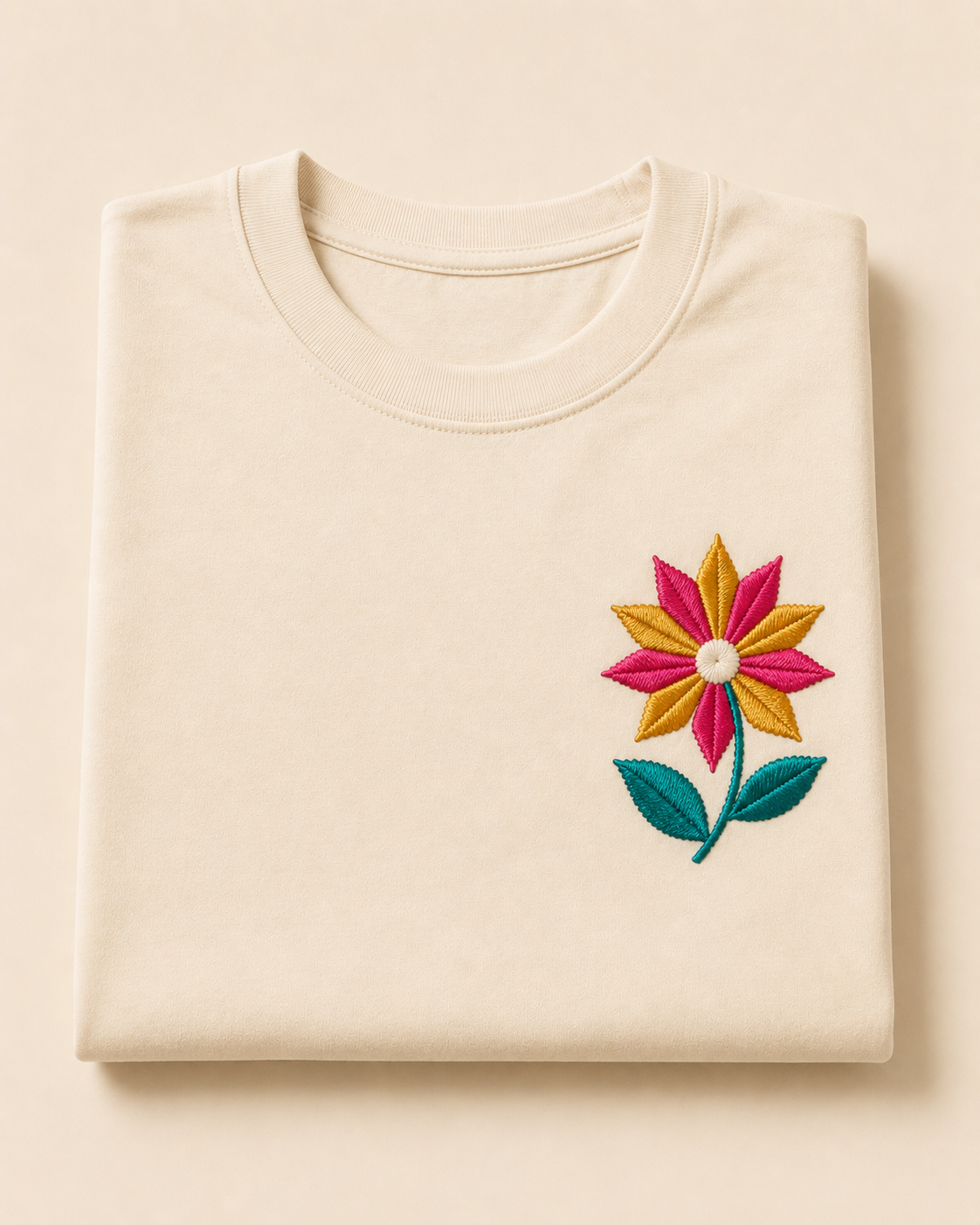 Cream cotton t-shirt with an embroidered Phulkari-style flower chest motif