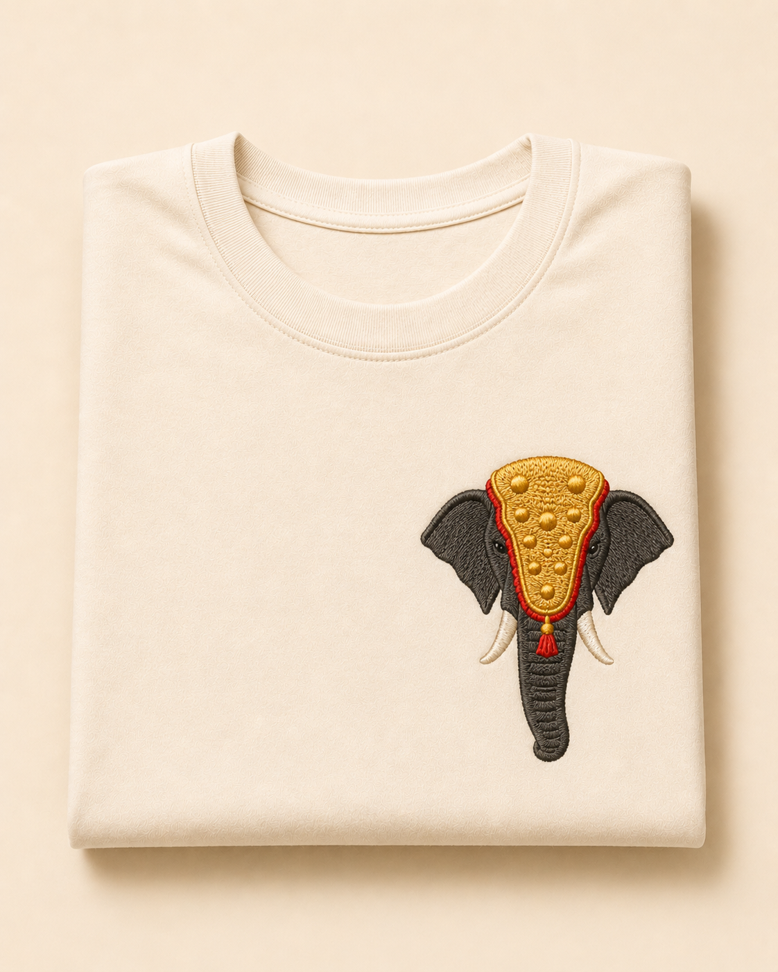 Cream cotton t-shirt with an embroidered caparisoned Kerala festival elephant chest motif