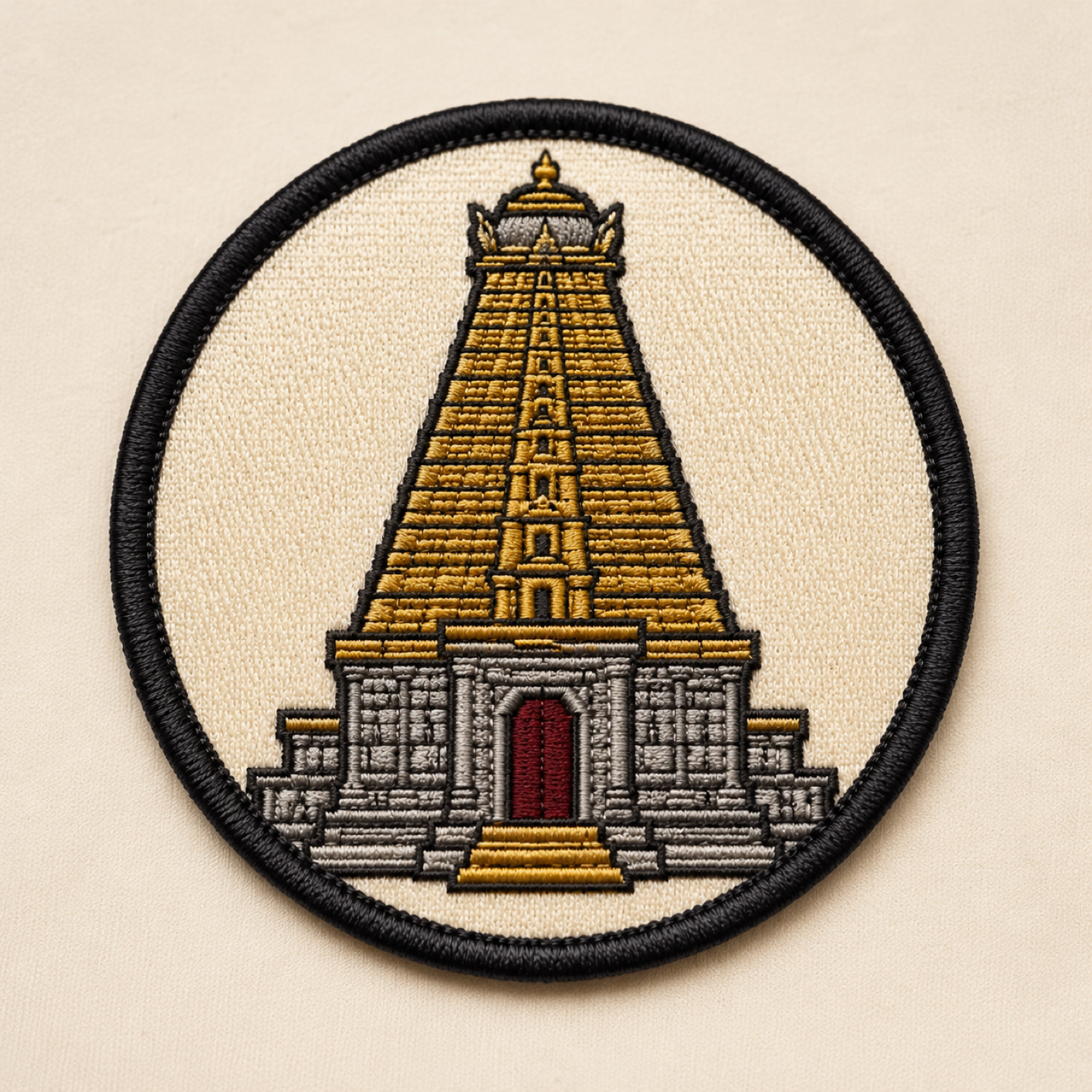Round embroidered Brihadeeswarar temple vimana patch with a black merrow border