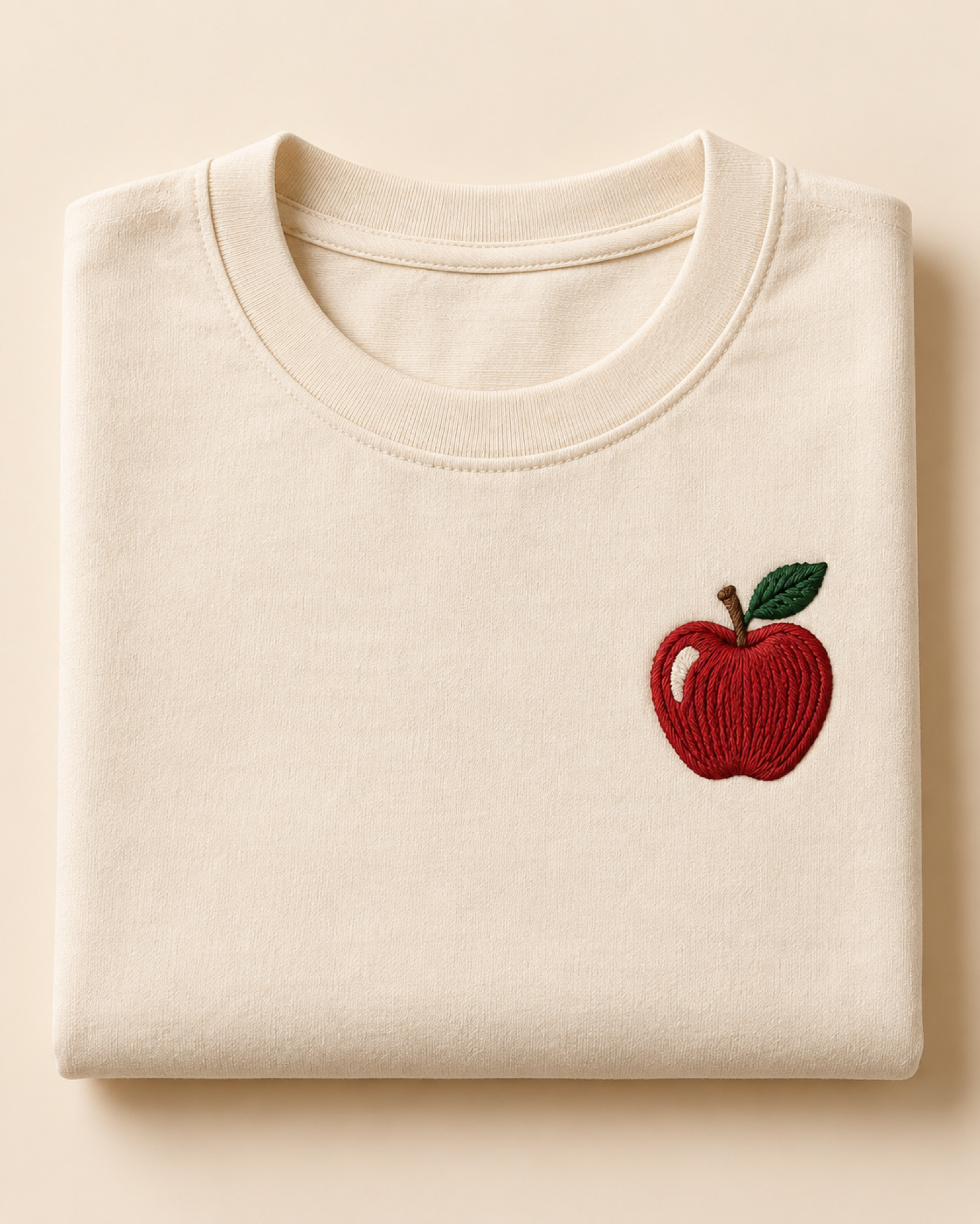 Machine-embroidered Himachal apple on a t-shirt